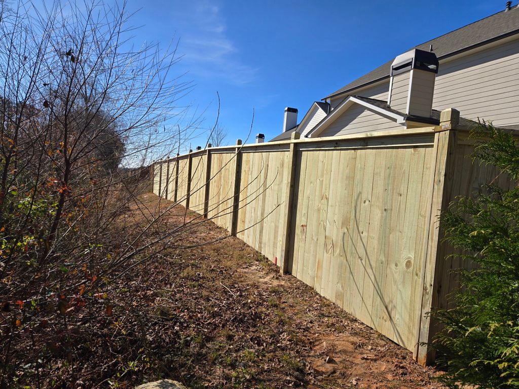 Fencing — 6' pressure-treated privacy fence with post caps